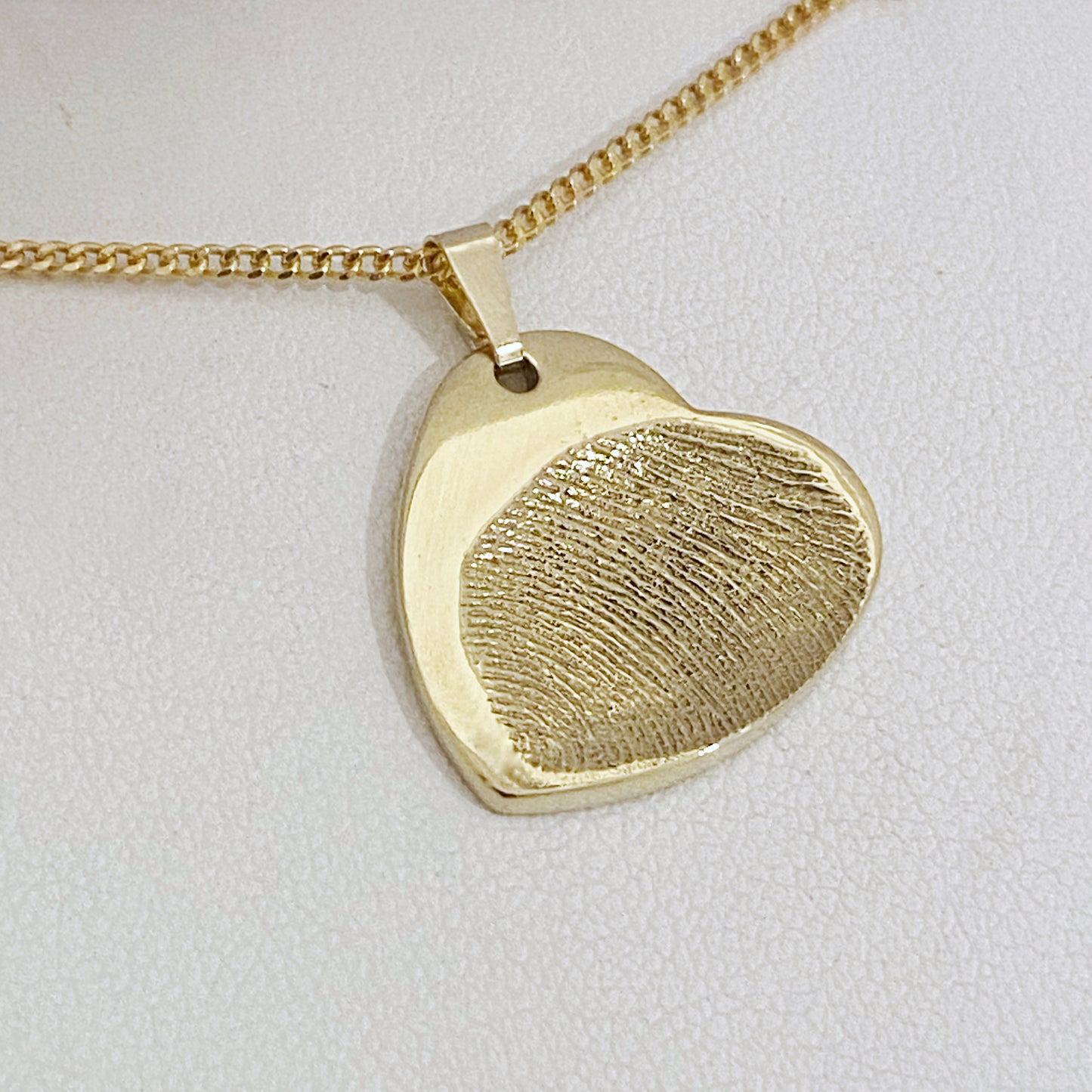 Gold Heart Fingerprint Pendant - Handcrafted keepsake capturing a fingerprint impression. Symbolizes love and connection