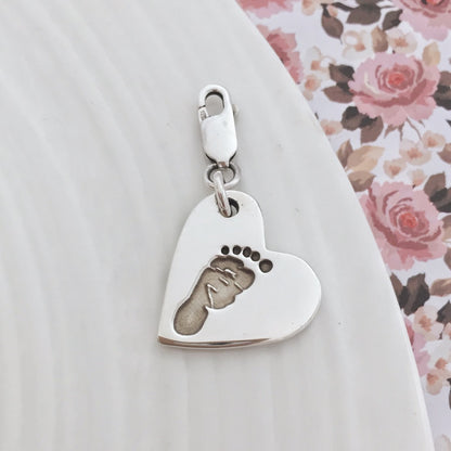 A way to show someone how much they mean to you, this custom handprint charm will be cherished for years to come. The front features your loved one's tiny hand or footprint while the back displays their name in elegant script. Choose from our selection of charms or create your own unique design by supplying us with a print from home!
