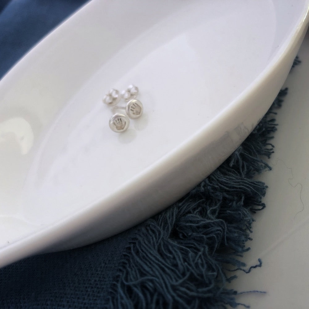 Our stud earrings are the tiniest of our handprint range, carrying the same level of care and attention to detail as our larger pieces. They come with your choice of either a discreet natural silver finish or an eye-catching blackened design that's sure to turn heads.